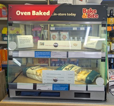 Baked goods display cabinet on a Sunday morning with display of alternatives to 'baked on the day' croissants and pains au chocolat